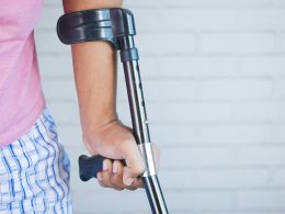 a person holding a crutch and walking cane