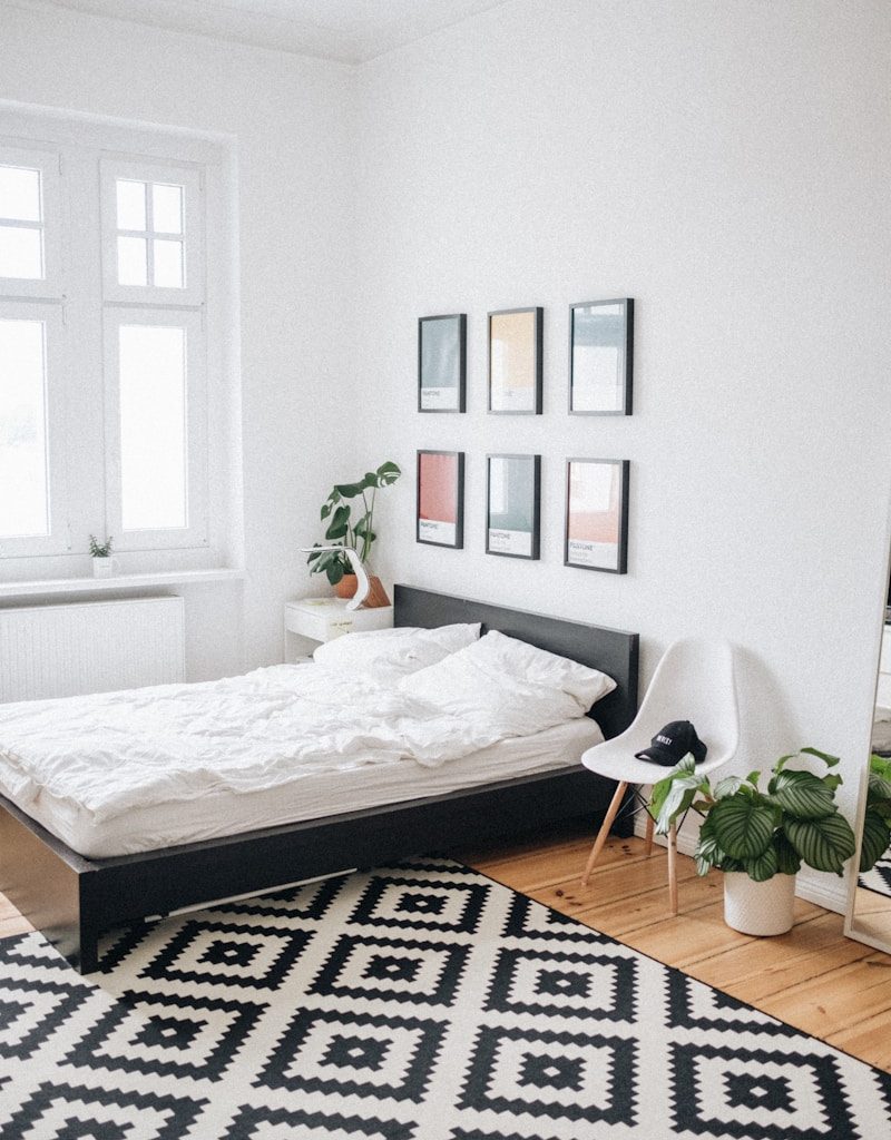 black platform bed with white mattress inside bedroom