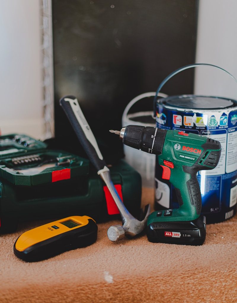 red and black cordless power drill beside black and red cordless power drill