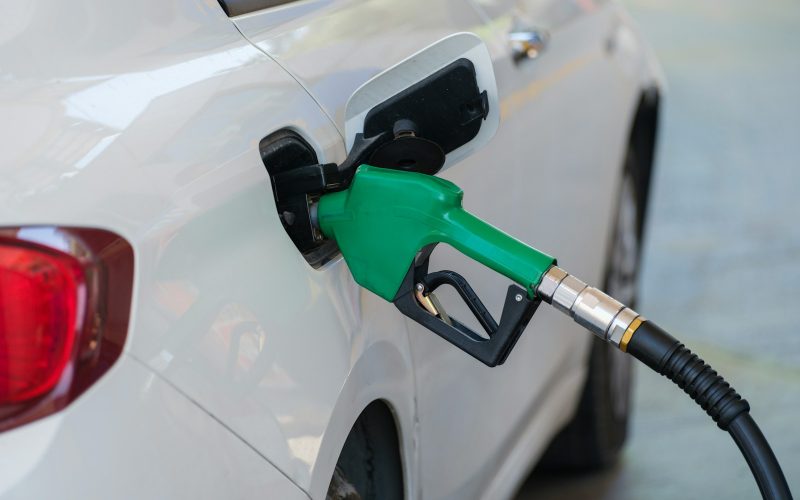 a white car with a green gas pump