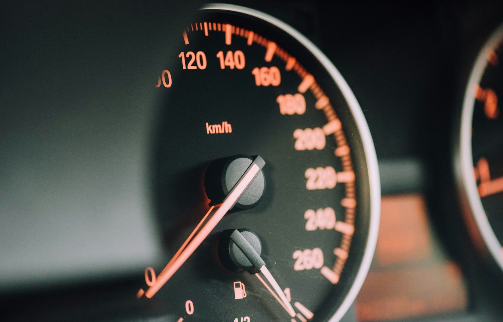 closeup photo of black analog speedometer