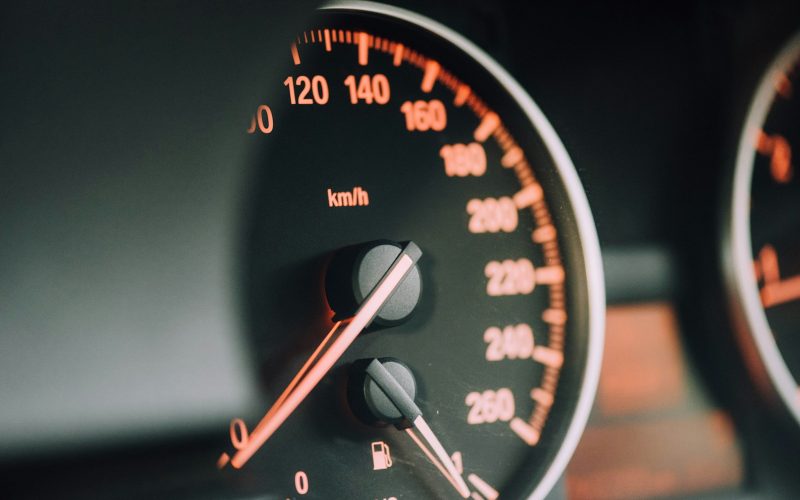 closeup photo of black analog speedometer