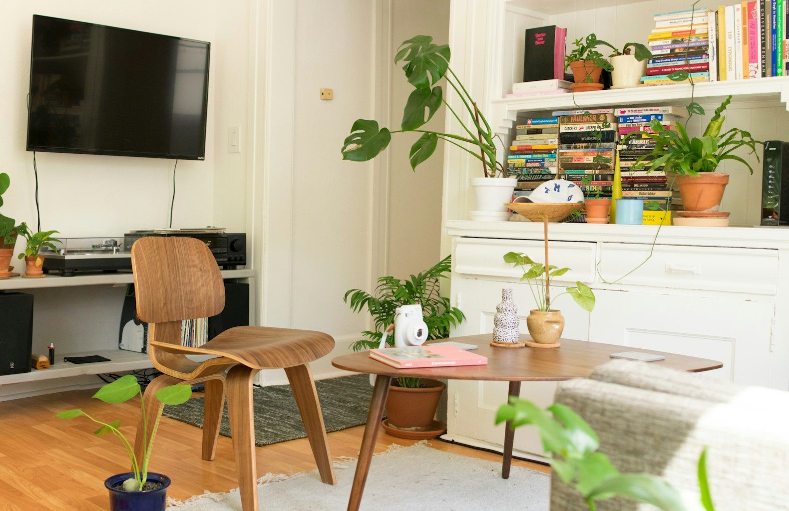 brown wooden table and chair beside bookshelf