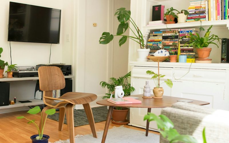 brown wooden table and chair beside bookshelf