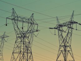 black transmission towers under green sky